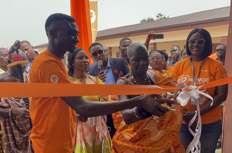 Nana-Bepow-I-Chief-of-Nyameyekrom-being-assisted-by-Eric-Osei-to-officially-commission-the-renovated-school