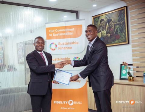 Fidelity-Bank-DMD-Mr.-Atta-Gyan-and-Executive-Director-of-UN-Global-Compact-Network-Ghana-Mr.-Tolu-Kweku-Lacroix-exchange-files-after-the-signing-ceremony